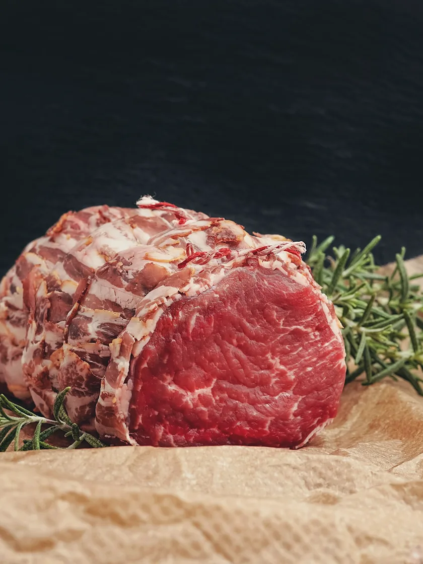 Raw rolled beef roast on butcher paper